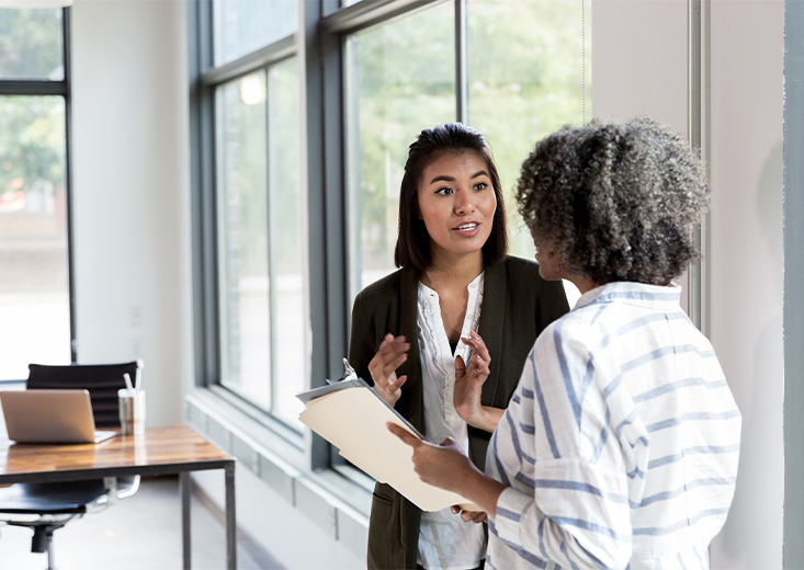 Healthcare administrator talking with employee