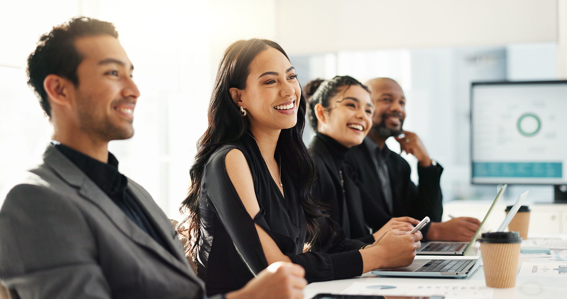 business administrators at conference table listening to speaker